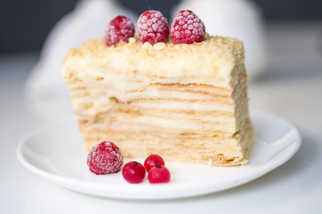 cake with raspberries and currants on a plate