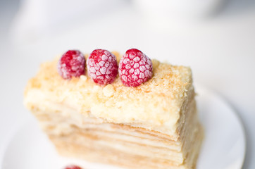 cake with raspberries and currants on a plate
