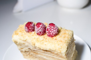 cake with raspberries and currants on a plate