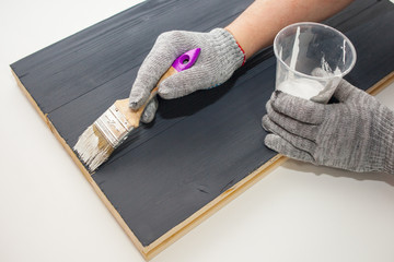 Master paints the Board with white paint. Create fotofone for advertising from wood. Toning the...