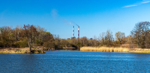 The beginning of spring on the Vistula in Krakow, in the background of the chimneys of Nowa Huta,...