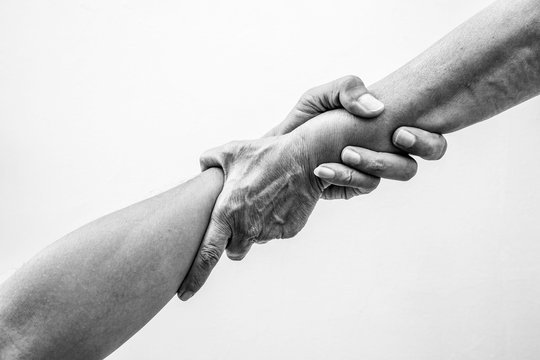 Help hands holding together in monochrome