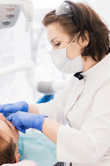 Aged man at the reception at the dentist. Woman doctor examines the patient's mouth