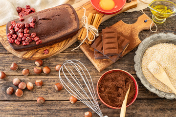 Cake with chocolate , cocoa , flour and hazelnut on the rustic wooden table
