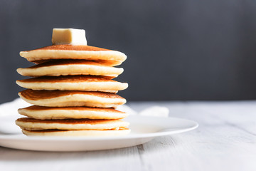 fresh classic pancake stacked in stack on gray background with place for text