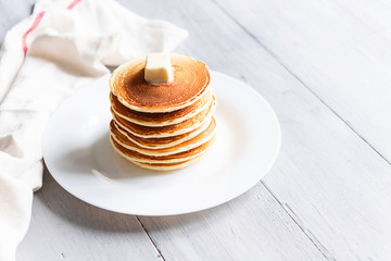 fresh classic pancake stacked in stack on gray background with place for text