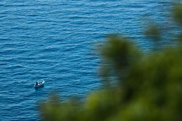 Bonassola, near Cinque Terre, Liguria. 03/31/2019. A fishing boat in the blue sea near the Five Lands. 