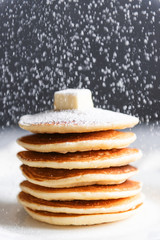 fresh classic pancake stacked in stack on gray background with place for text
