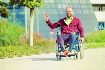 Fototapeta na wymiar happy man on wheelchair waving