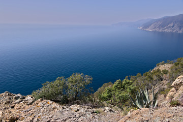 Cinque Terre, Liguria, Italy. Rocks overlooking the blue sea. The sea coast of the Five Lands with rock walls and rocks