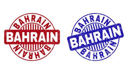 Grunge BAHRAIN round stamp seals isolated on a white background. Round seals with grunge texture in red and blue colors. Vector rubber watermark of BAHRAIN text inside circle form with stripes.