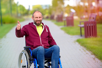 happy man on wheelchair showing OK