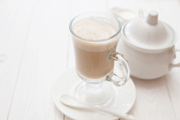 Raf coffee in transparent glass on a light wooden background. Delicious Russian most popular drinks. 