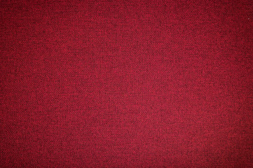 Textured background surface of textile upholstery furniture close-up. red Color fabric structure