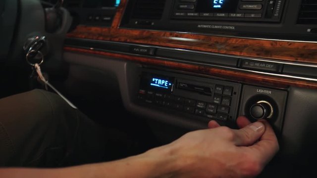 Close-up shot of tape car radio recorder with lighten buttons.