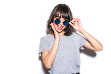 Stunning short-haired stylish european girl posing with expression on white background.