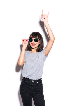 Crazy girl in t-shirt and rock sunglasses scream holding her head Rocky woman isolated on white background