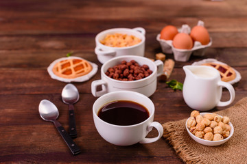 Fototapeta na wymiar Tasty and useful breakfast with flakes, milk, nuts and dried fruits. The healthy food loading with energy