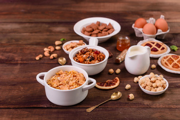 Tasty and useful breakfast with flakes, milk, nuts and dried fruits. The healthy food loading with energy