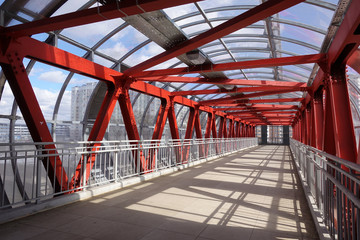 Overhead passage. Bolted steel beams. Painted in red. Interior.