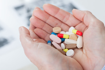 Pills on female hands cloce up. Suicide concept