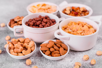 Tasty and useful breakfast with flakes, milk, nuts and dried fruits. The healthy food loading with energy