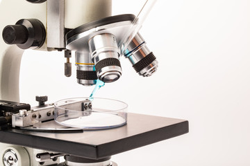 Close up shot of microscope and yellow dropper..