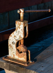 ancient bench vise in colors at harbour