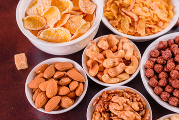 Tasty and useful breakfast with flakes, milk, nuts and dried fruits. The healthy food loading with energy