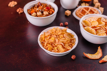 Tasty and useful breakfast with flakes, milk, nuts and dried fruits. The healthy food loading with energy