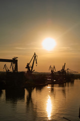 Obraz premium Golden sunset over shipyard in Gdansk, Poland