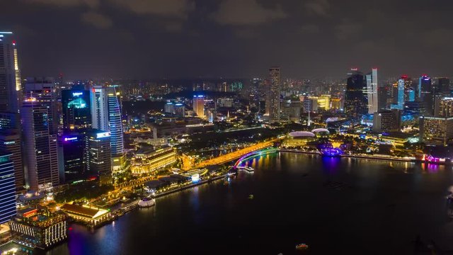 night time illuminated singapore city flight over famous hotel bay aerial panorama 4k timelapse