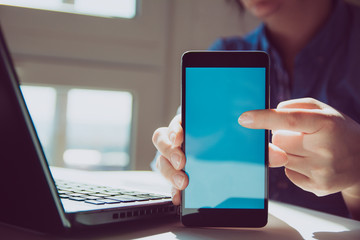 Close up of woman's hands using smart phone touchscreen