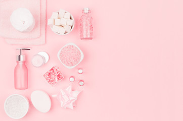 Modern exquisite set of cosmetic products and accessories in pastel pink color, copy space, flat lay.