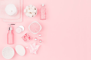 Modern exquisite set of cosmetic products and accessories in pastel pink color, copy space, flat lay.