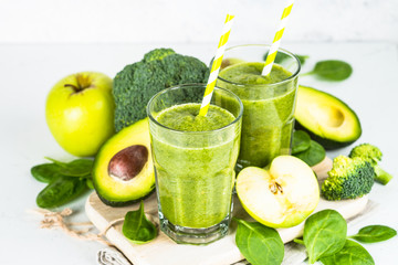 Green smoothie from fruit and vegetable on white.