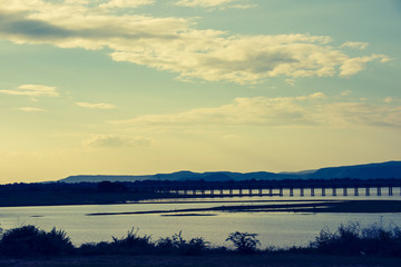 Landscape View of  Train crossing Pasak Chonlasit Dam. Reservoir for agriculture at Lopburi,Thailand