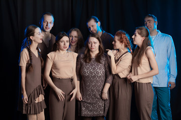 The actors on the stage play an emotion performance on a black background in stage light
