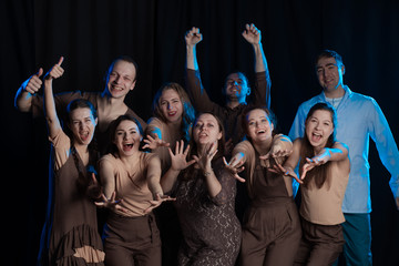 The actors on the stage play an emotion performance on a black background in stage light