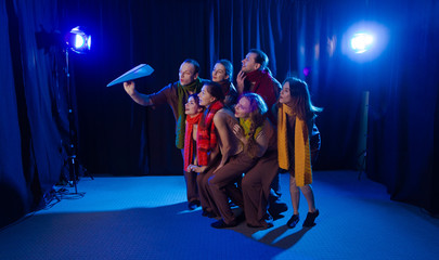 The actors on the stage play a performance and look at a blue paper plane.