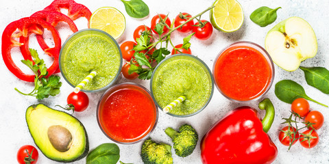 Red and Green vegetable smoothie on white.