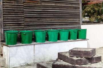 Obraz premium Rural devices stand against the background of the wooden house