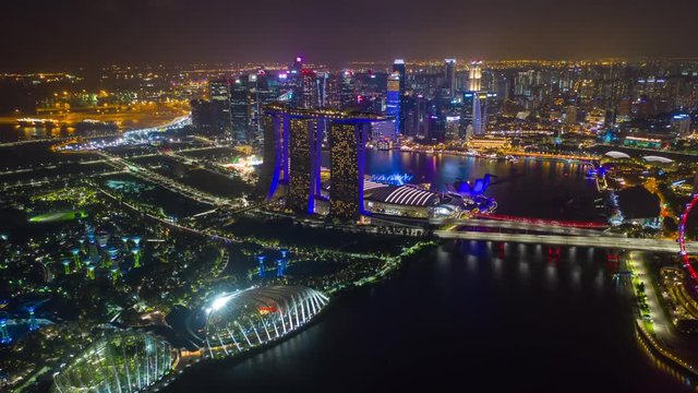 night time illuminated singapore city flight over famous hotel gardens bay aerial panorama 4k timelapse