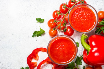 Tomato vegetable juice in glass on white.