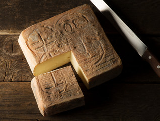 Taleggio cheese on the wooden table - 259122242