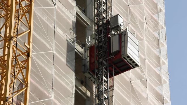 Construction Elevator Going Up Building Wall