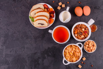 Tasty and useful breakfast with flakes, milk, nuts and dried fruits. The healthy food loading with energy