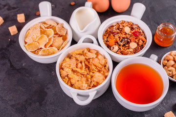 Tasty and useful breakfast with flakes, milk, nuts and dried fruits. The healthy food loading with energy