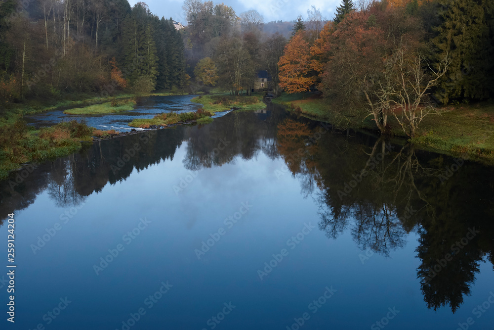 Wall mural View on the river Semois in Chiny Belgium with reflections in Autumn