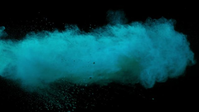 Super slowmotion shot of blue powder explosion isolated on black background.